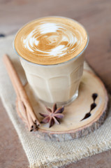 a glass of hot coffee on wooden table