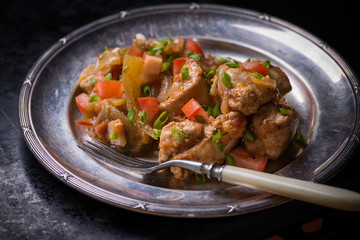 Chicken stew with onion, pepper ant tomato
