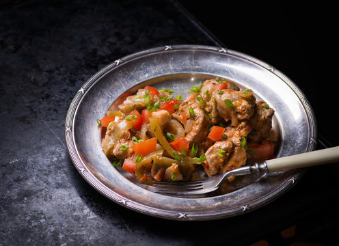 Chicken stew with onion, pepper ant tomato