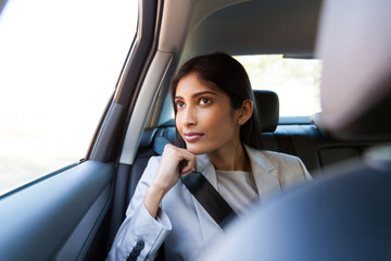young indian businesswoman sitting in car
