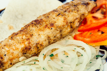 Fried fish with onions and tomato slices