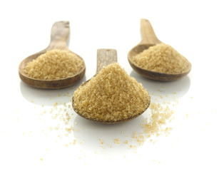 raw brown cane sugar on white background