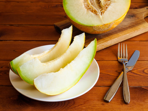 Fresh juicy melon on a wooden table background