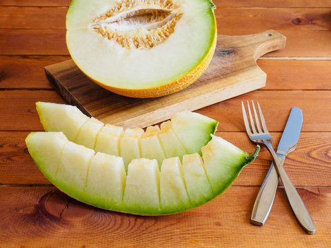 Honeydew  melon sliced on wooden background