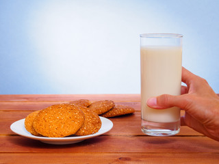 Oatmeal cookies on plate and glass with milk