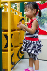 Asian Kid playing on Playground