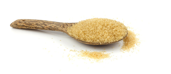 Raw brown cane sugar on white background