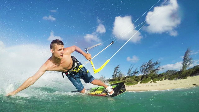 Young Man Kite Boarding in Ocean. Extreme Summer Sport in Slow Motion.