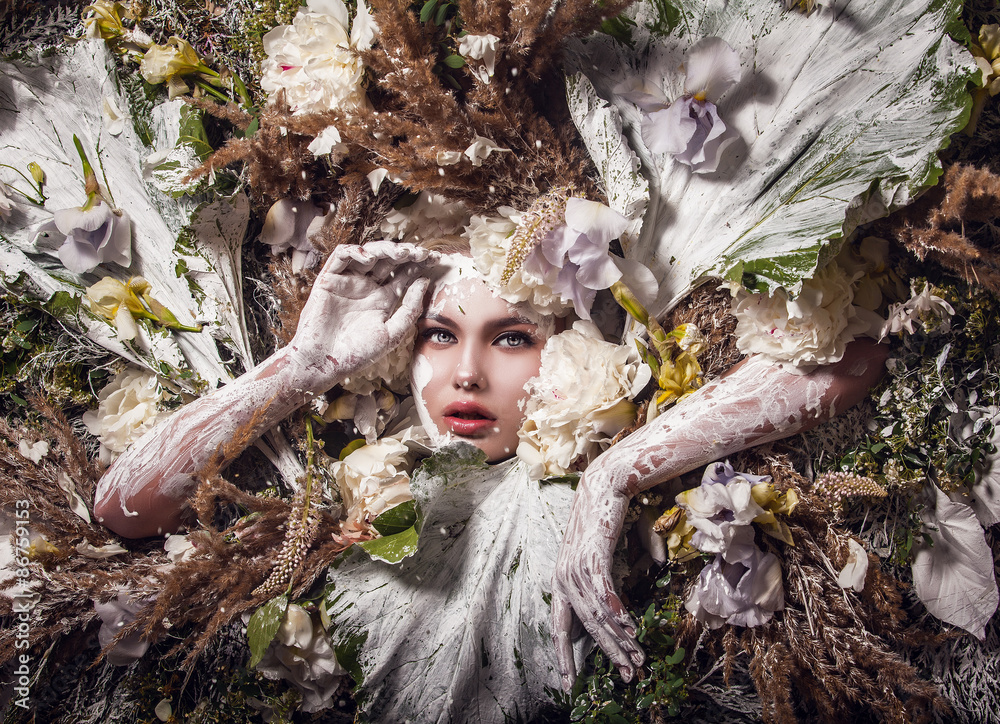 Poster fairy tale girl portrait surrounded with natural plants and flowers. art image in bright fantasy sty