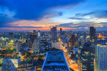 Bangkok City skyline aerial view at sunset with colorful clouds and skyscrapers of midtown bangkok.
