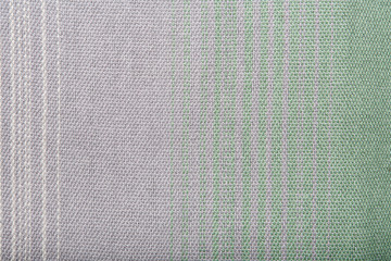 Fototapeta premium Handmade fabric with green and gray striped texture. Clothes background