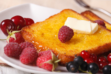 sweet French toast with syrup and fresh berries close-up