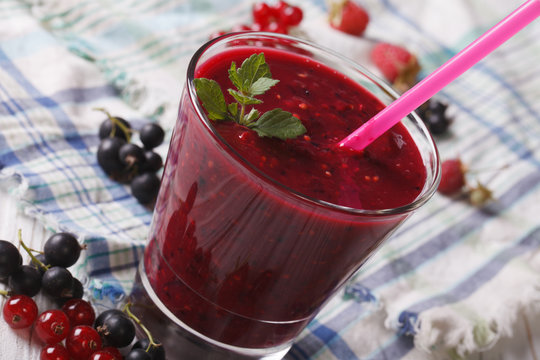 Delicious smoothies with fresh berries in a glass close-up. horizontal