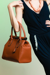 stylish woman fashion girl holding brown handbag