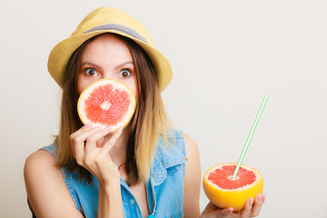 Summer girl tourist holding grapefruit citrus fruit
