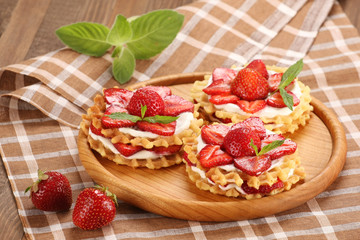 Strawberry dessert with cream on a wooden dish