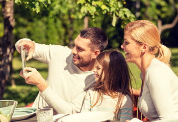 happy family with tablet pc outdoors
