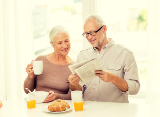 happy senior couple having breakfast at home