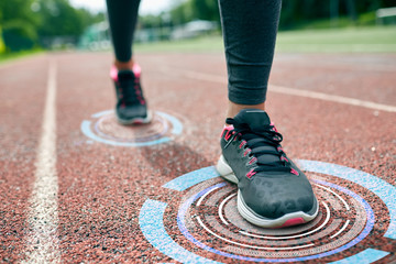 close up of woman feet running on track