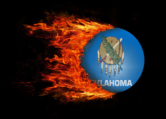 US state flag with a trail of fire - Oklahoma