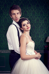 Happy bride and groom on green retro interior