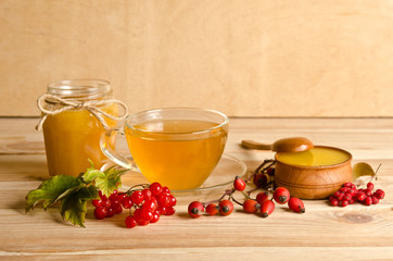 Still life from cup of tea , honey and  berries