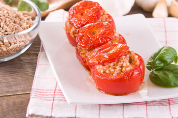 Stuffed tomatoes on a white plate.