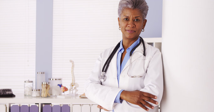 African Senior doctor standing in office 