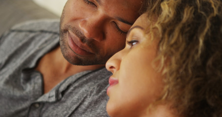 Black couple resting their heads together