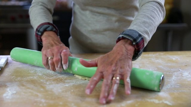 woman rolls pie crust