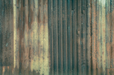 Rusty corrugated metal wall in vintage color style