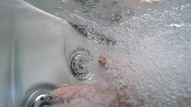 hot tob bubbles and a hand in exreme slow motion