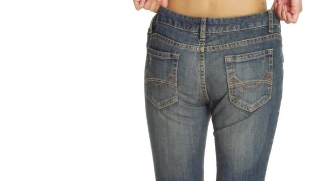 Attractive Asian woman putting on a pair of jeans