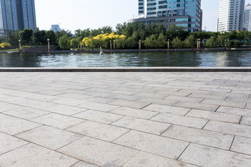 Empty road floor and river in modern city