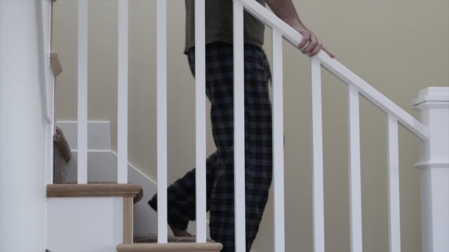 Man walking up the stairs in his home