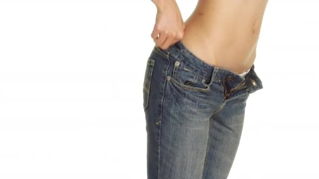 Closeup of a sexy woman putting on a pair of jeans