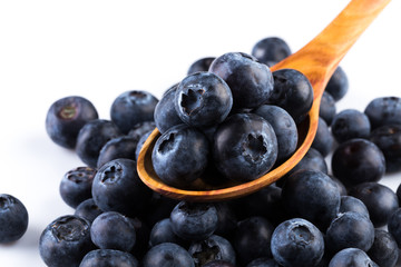 Fresh blueberries in wooden spoon