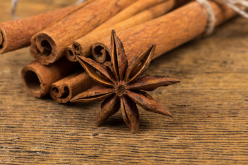 Close up of cinnamon sticks and star anise on wood