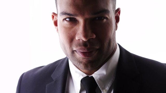 Attractive black man looking at camera wearing suit