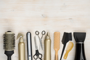 Hairdressing tools on wooden background with copy space at top - obrazy, fototapety, plakaty