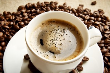 Macro coffee with foam at breakfast on fabric linen