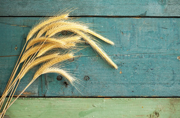 Wheat Ears on the Wood Background