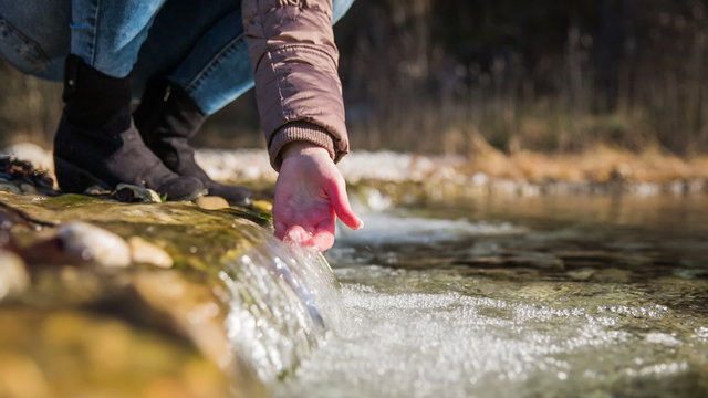 Person capture water with hand in nature