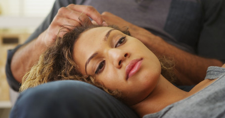 Closeup of girlfriend lying on boyfriend's lap