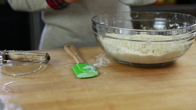 adding ice water to make pie crust dough