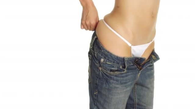 Closeup of Sexy Chinese woman putting on a pair of jeans