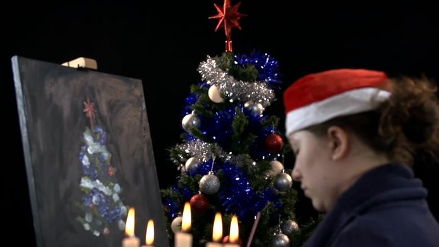 Creative artist making Christmas tree on canvas