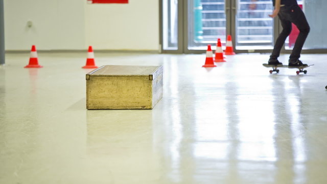 Person skating and sliding on box close up