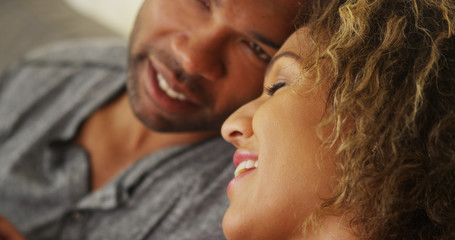 Black couple resting their heads together