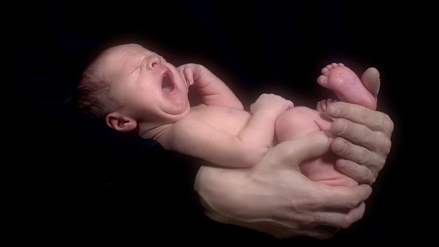 Newborn Baby On Black Background Yawning in Slow Motion